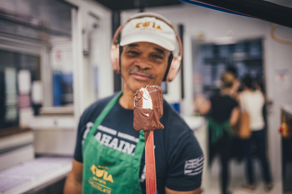 Dennis holding a spatula covered in chocolate